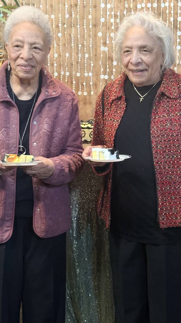 Two Bennett elders holding plates at a reunion