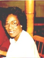Ms. Georgia Bennett, smiling, seated at a table